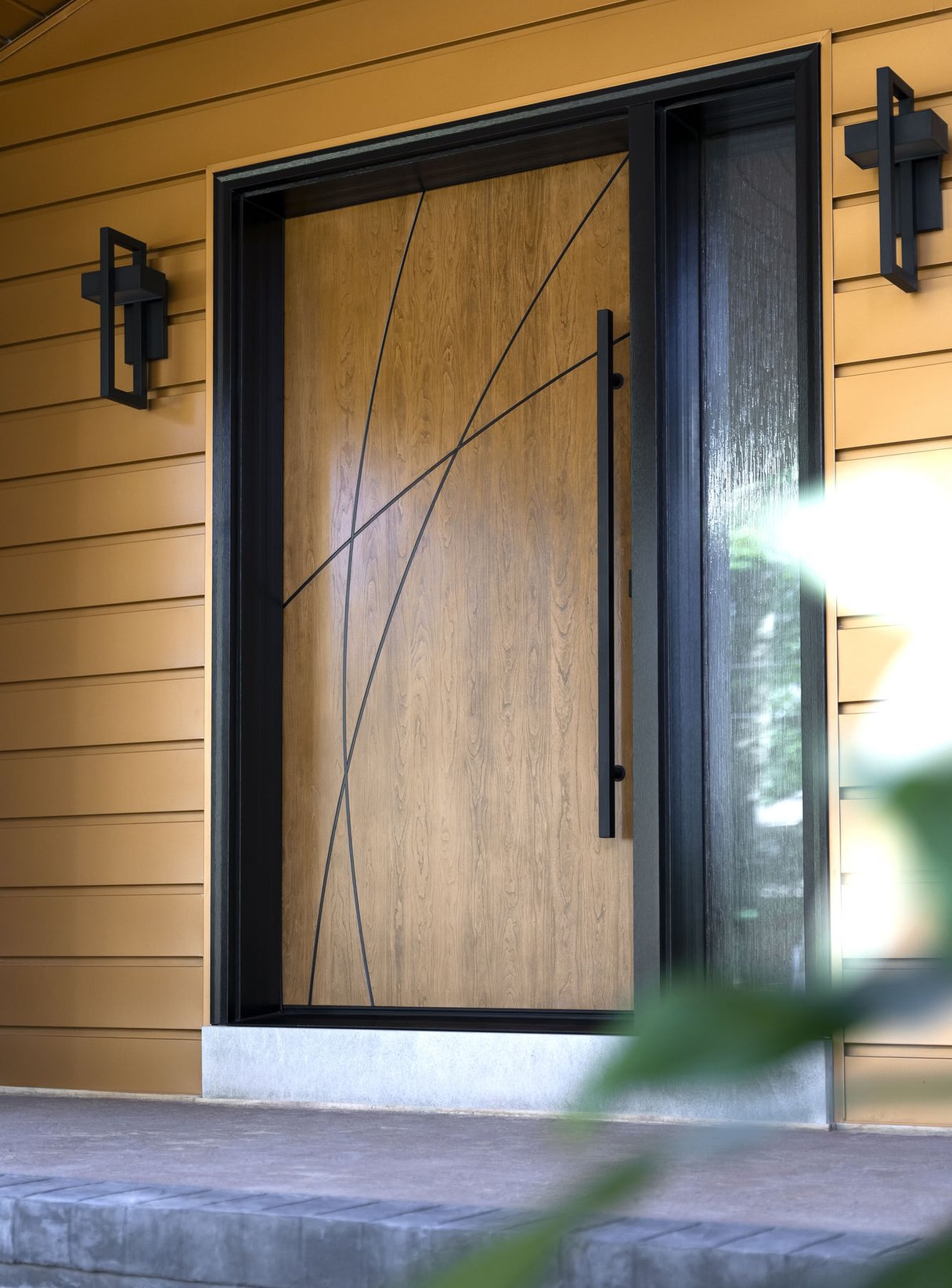 Modern wood door with geometric design and black frame.
